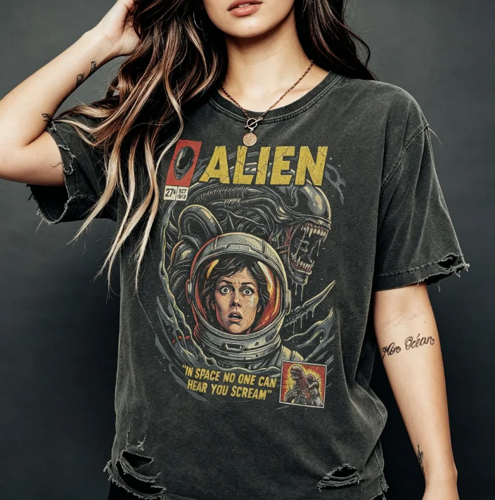 A Retro Black 1979 Alien Movie Themed Printed T-shirt with A Classic Ripley Spacesuit and Alien Design on The Chest