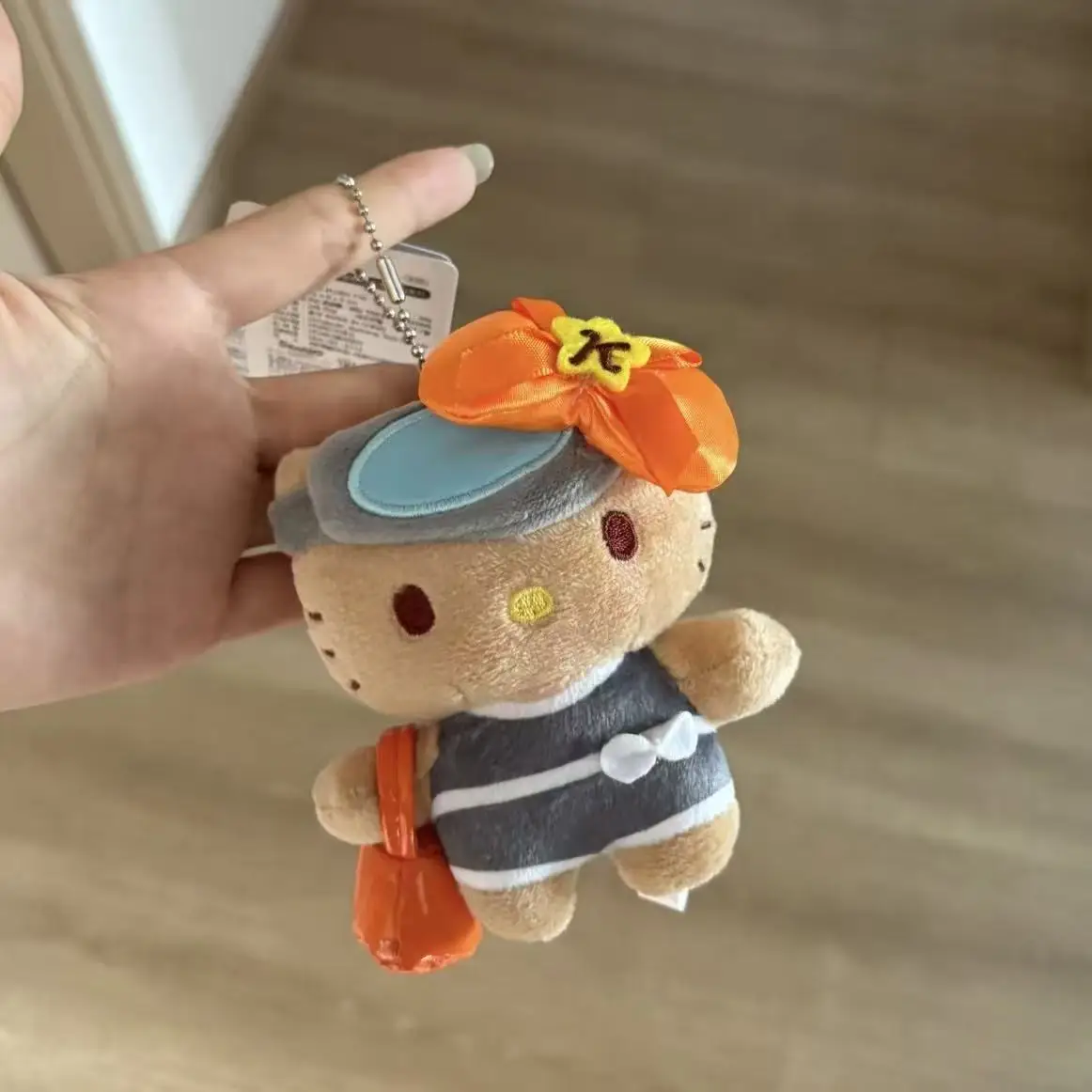 2025 Sanrio HelloKitty pendentif en peluche MINISO dessin animé Jeju île peau noire Kitty porte-clés décoration de sac à dos pour enfants