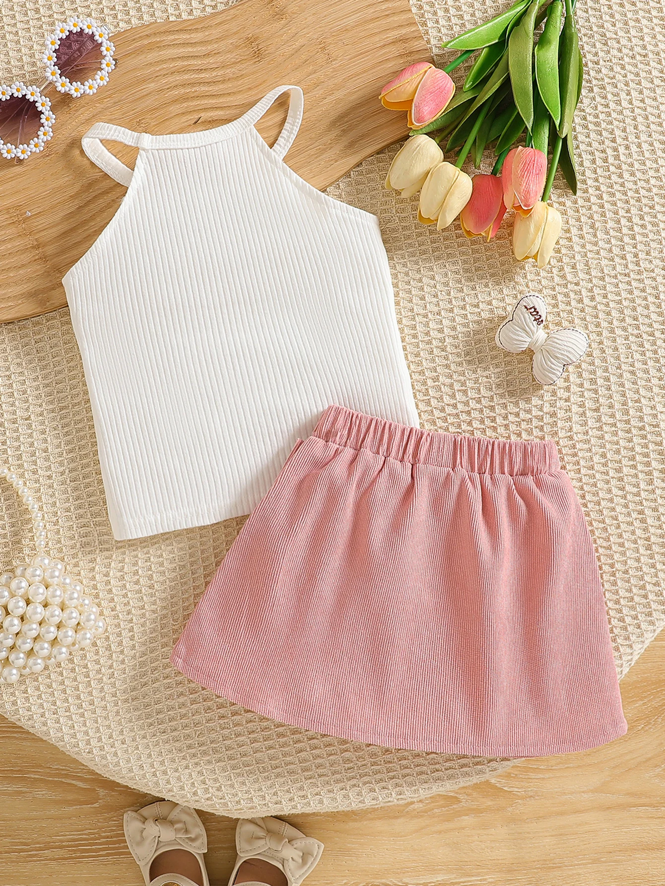 Conjunto de dos piezas de moda para niña con cuello colgante, Top sin mangas y falda corta con decoración de lazo