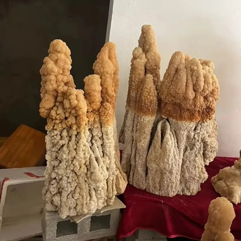 Decorative handicrafts are clustered with natural stalactites, coarse stalagmites, and calcite clusters