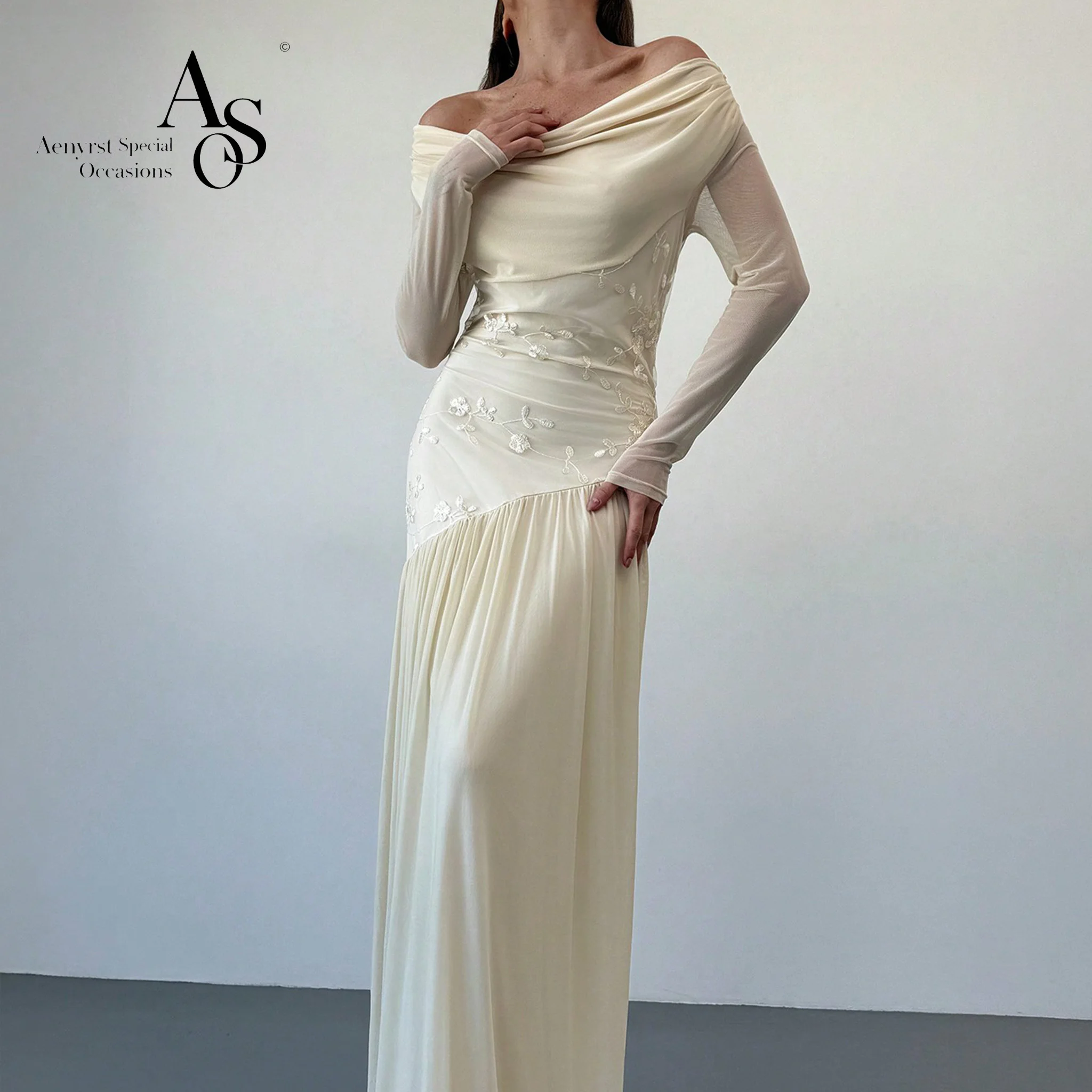 Ivory white chiffon off-the-shoulder long-sleeve formal gown featuring draping embroidery and an open back