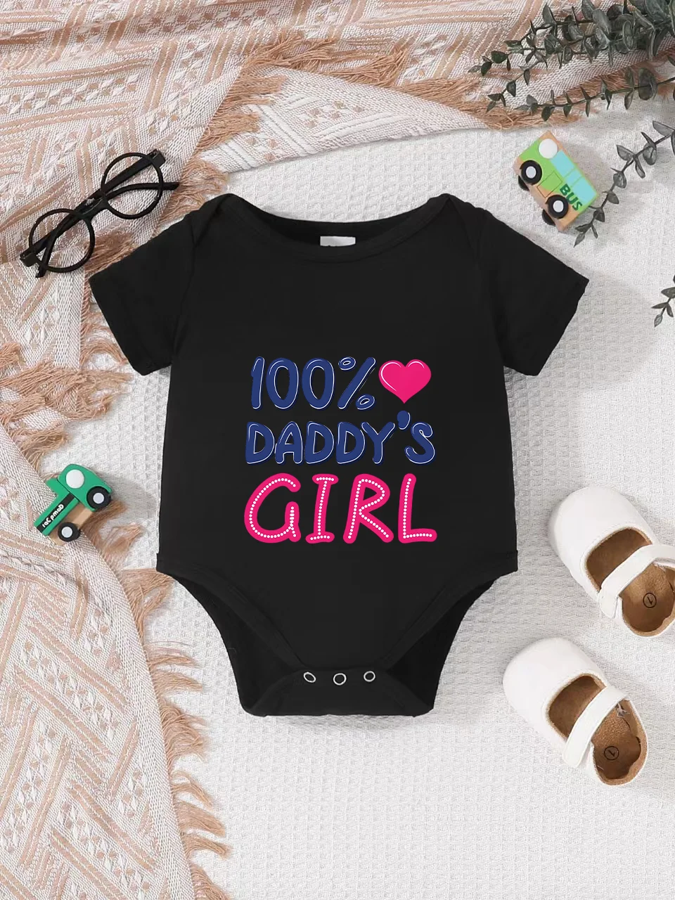 Playful letter-printed baby short-sleeve triangle bodysuit. Button closure for easy dressing