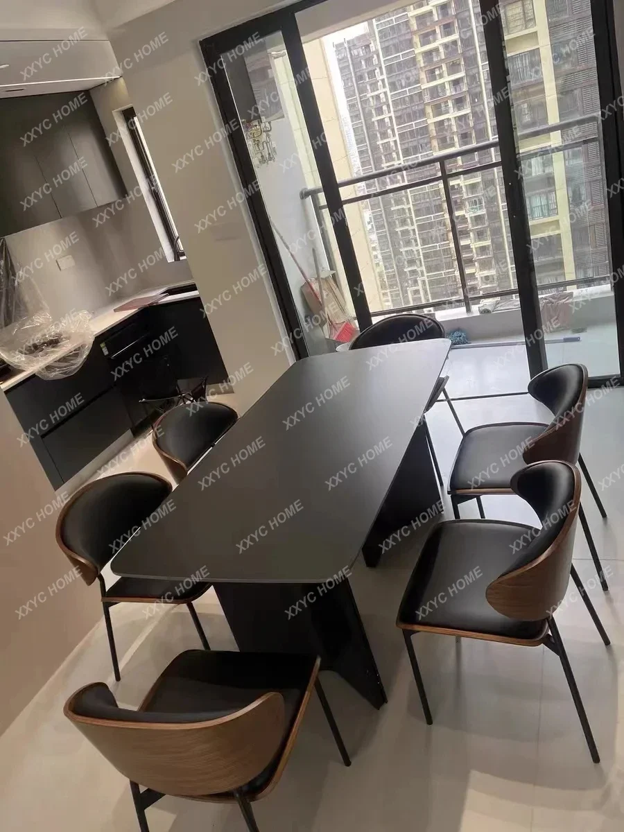 

A minimalist modern black rock slab dining table rectangular retro wabi-sabi style
