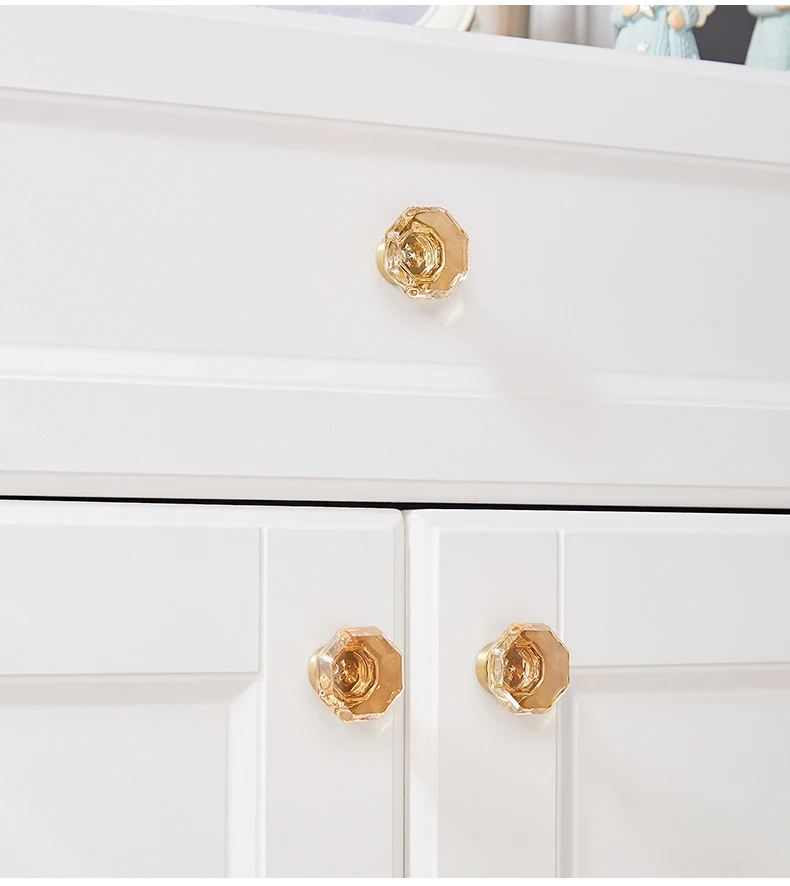 Faceted champagne glass knobs on white furniture