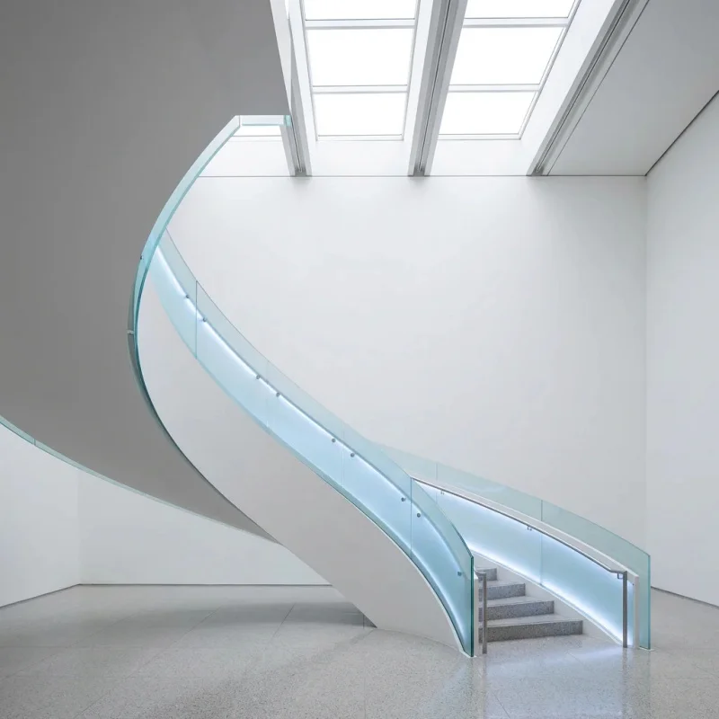 custom.Signature Curved Staircase Architectural Centerpiece With Frameless Glass Guard Modern Mansion Interior