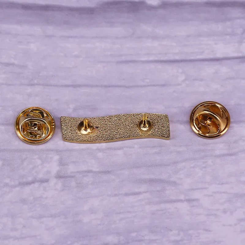 Feminist AF brooch with a purple background and golden letter logo badge