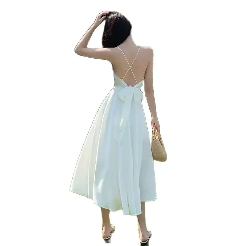 Beach vacation backless suspender dress for women's summer new white bow temperament medium length dress