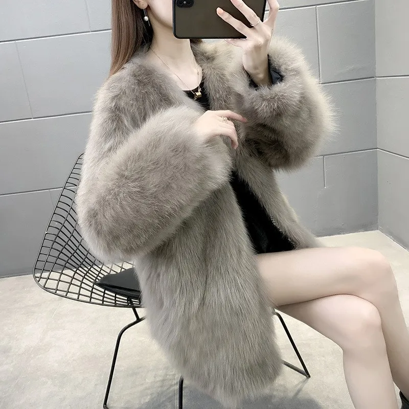 This is a women's fur coat with light and long collar