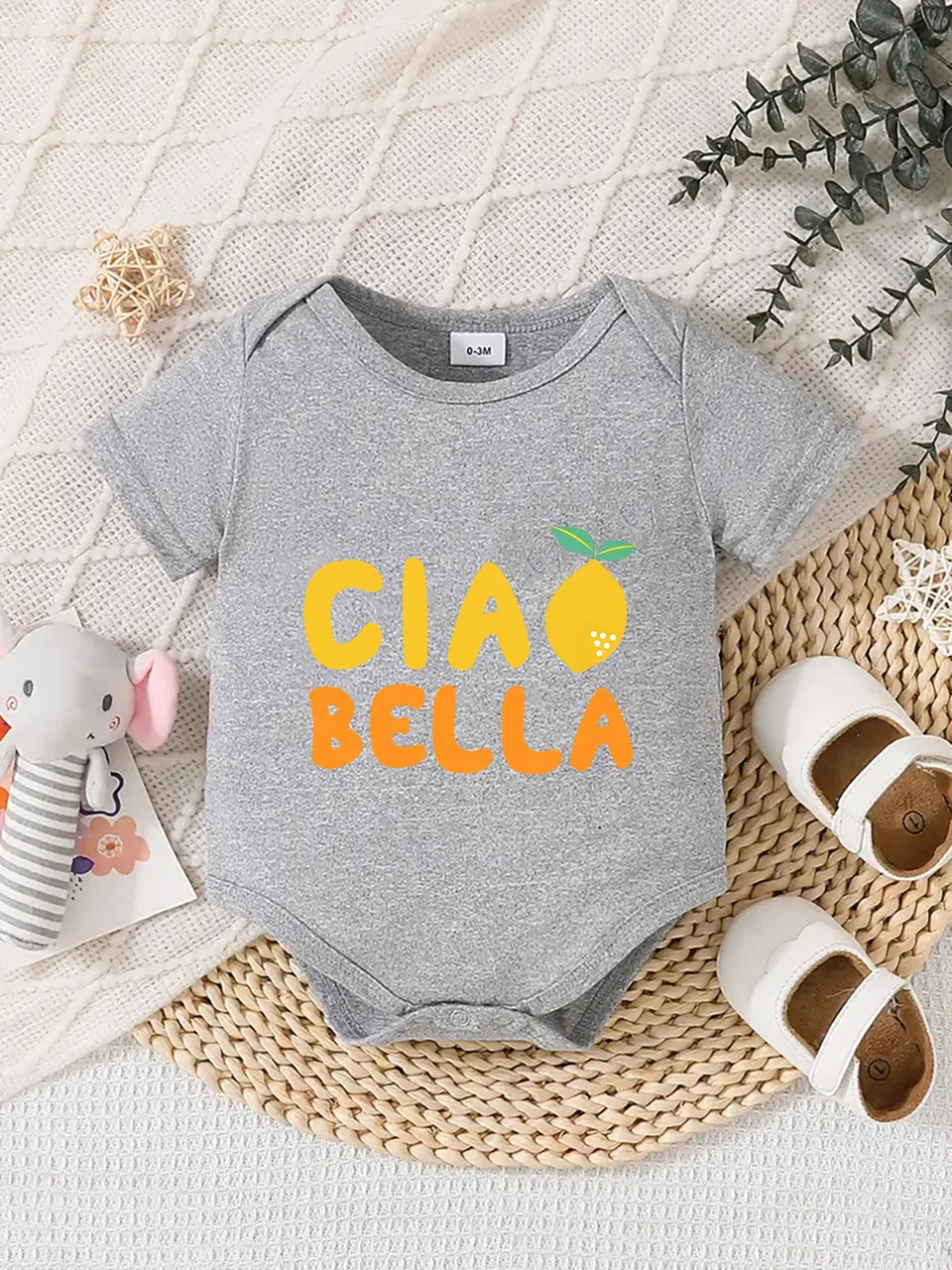 Playful letter-printed baby short-sleeve triangle bodysuit. Button closure for easy dressing