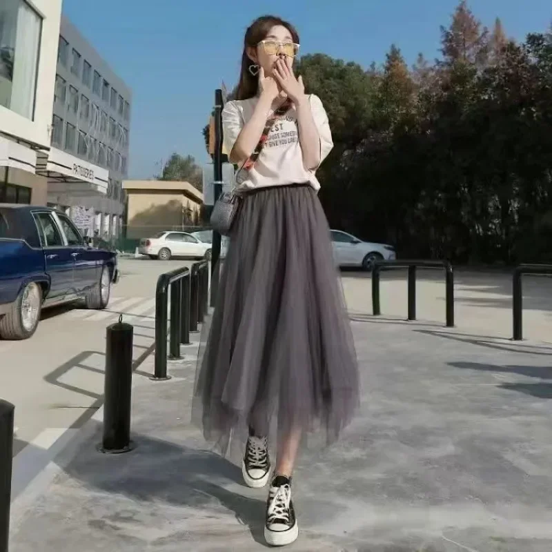 تنورة متوسطة الطول شفافة على شكل حرف A عالية الخصر - تنورة نسائية مكشكشة شبكية ذات طبقات غير متناظرة باللون الأسود