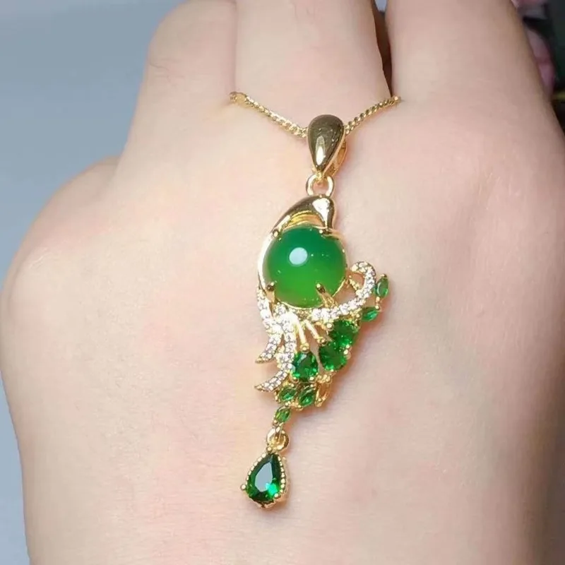 Set of two earrings featuring a mosaic of green zircon and a peacock spreading its wings.