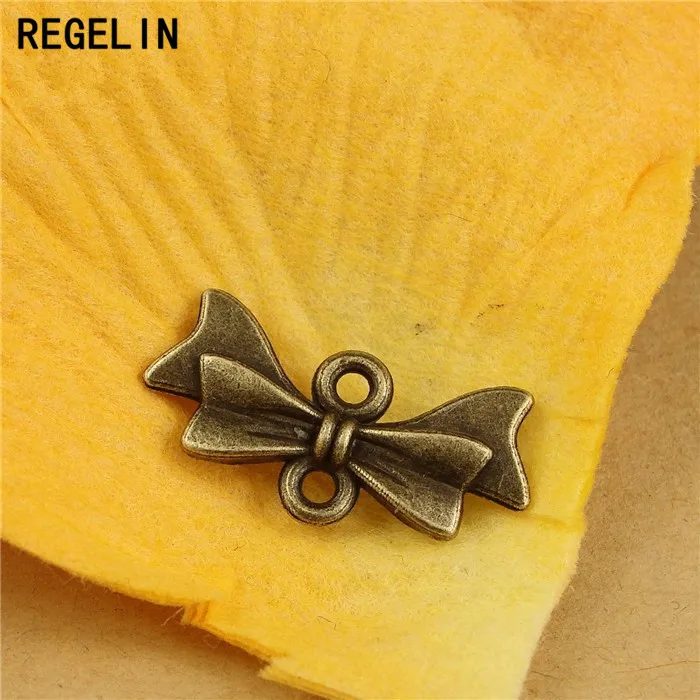 

REGELIN Charms Bow Tie Connectors Pendant Antique bronze Zinc Alloy 50pcs 21x10mm Fit Bracelet Necklace DIY Jewelry Findings