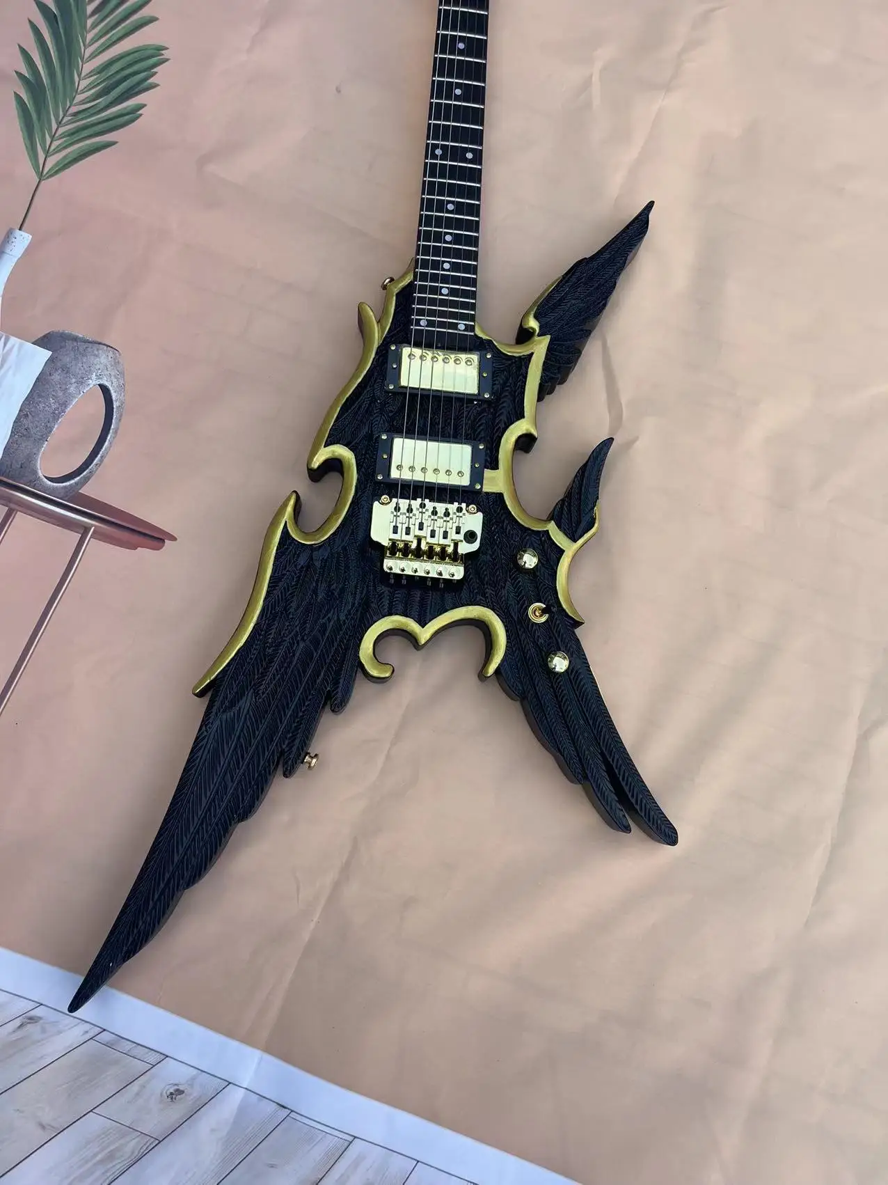 

Spot Angel Wings Carving Electric Guitar, Matte Black Body, Gold Accessories, Factory Realistic Photo, Order and Ship