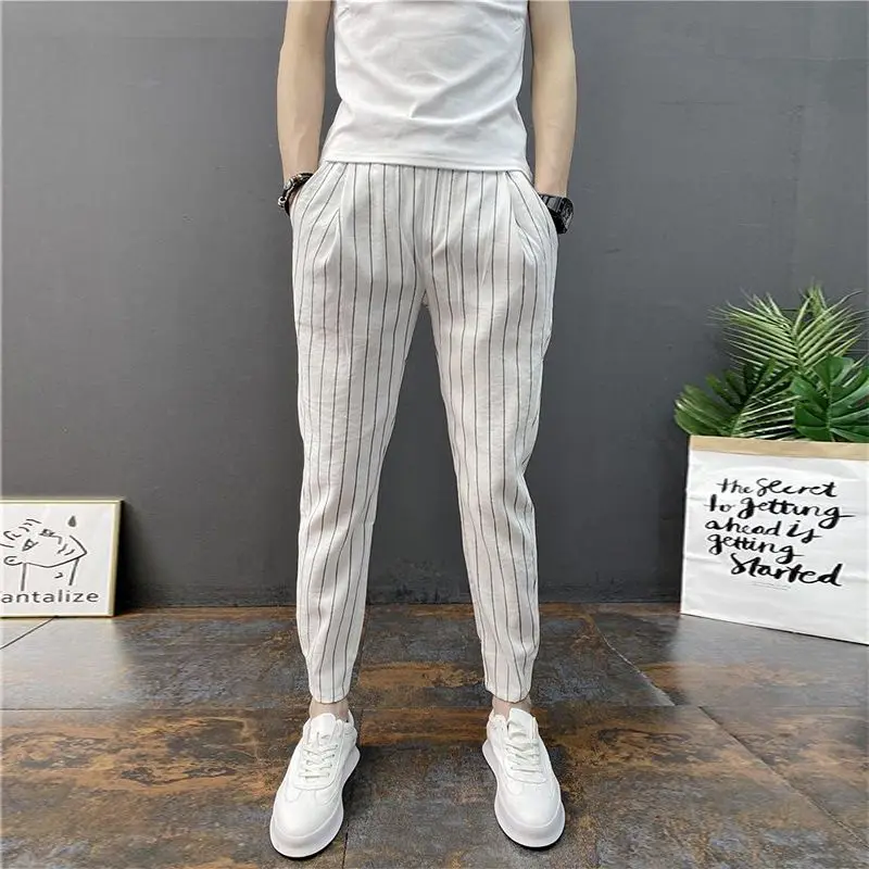 Pantalones pitillo a rayas para hombre, pantalón informal de cintura elástica, con bolsillos, de retales, primavera y verano, novedad