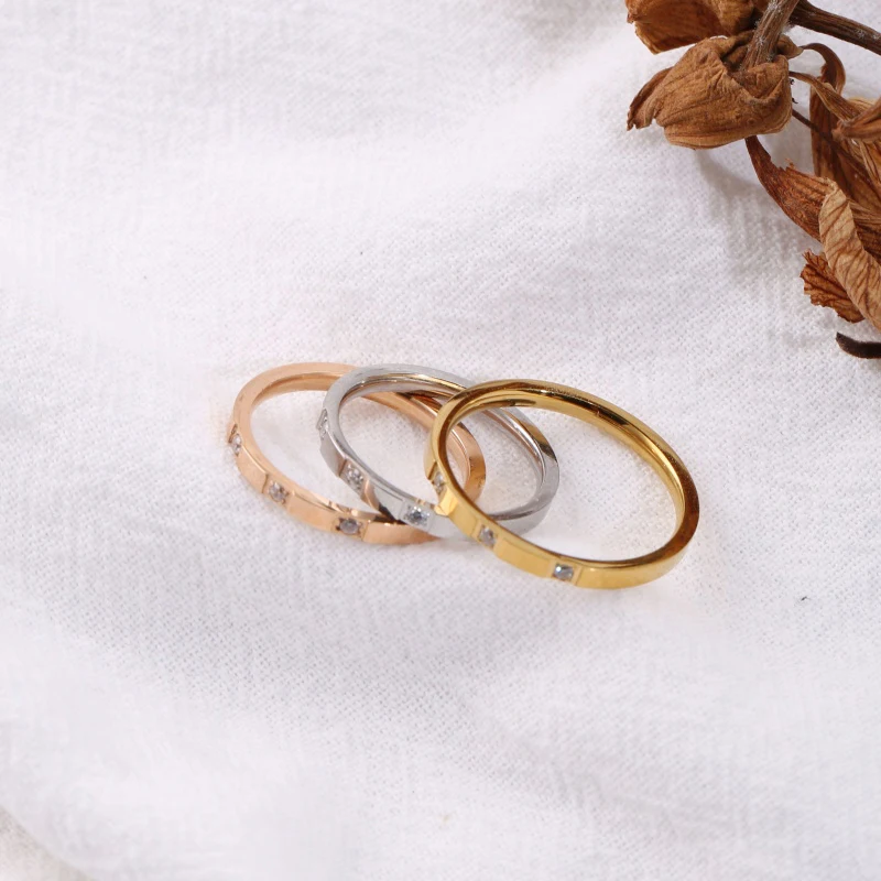 1 piece stainless steel 18K gold-plated ring with 3 rhinestones in a square pattern. Available in multiple colors, this light luxury ring features a simple and elegant style that suits various outfits. It is a delicate and versatile accessory suitable for layering