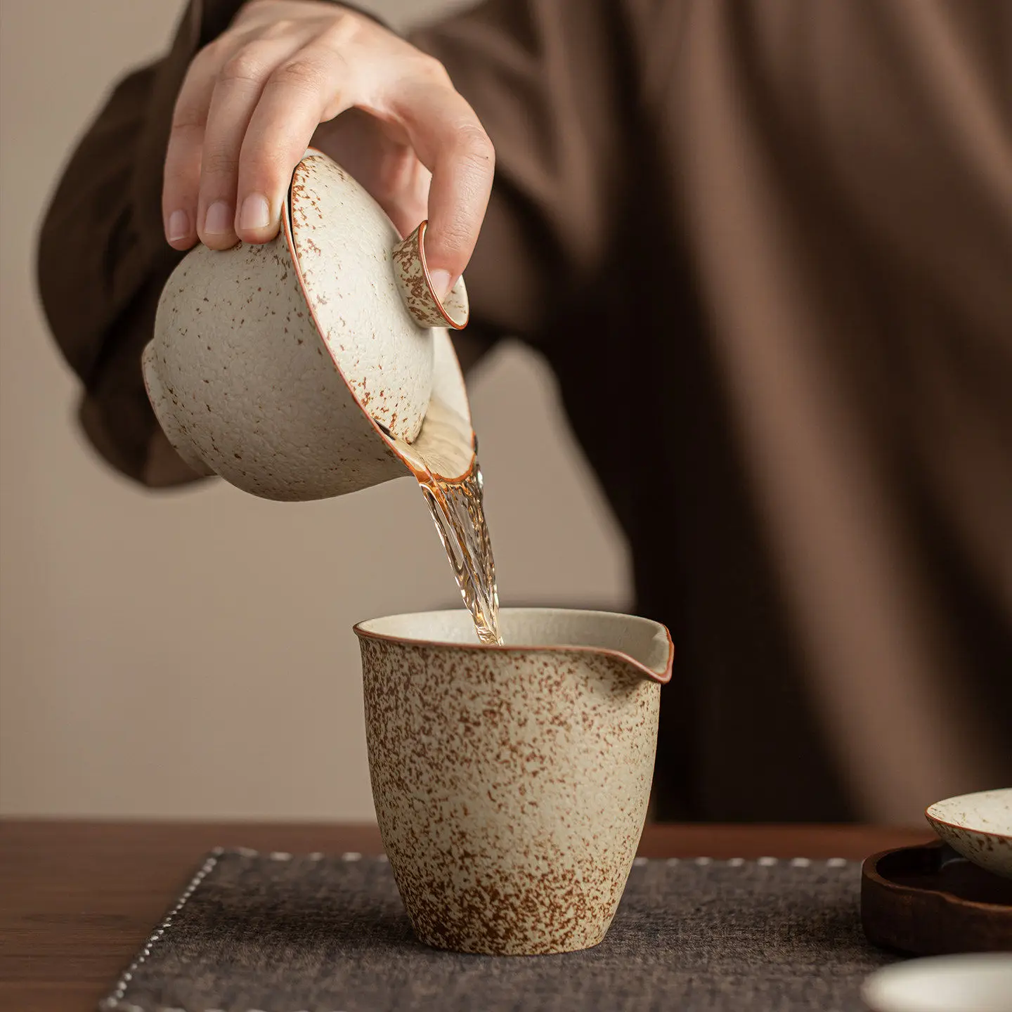 Pouring tea from the Firestone Gaiwan set with a clean, smooth flow