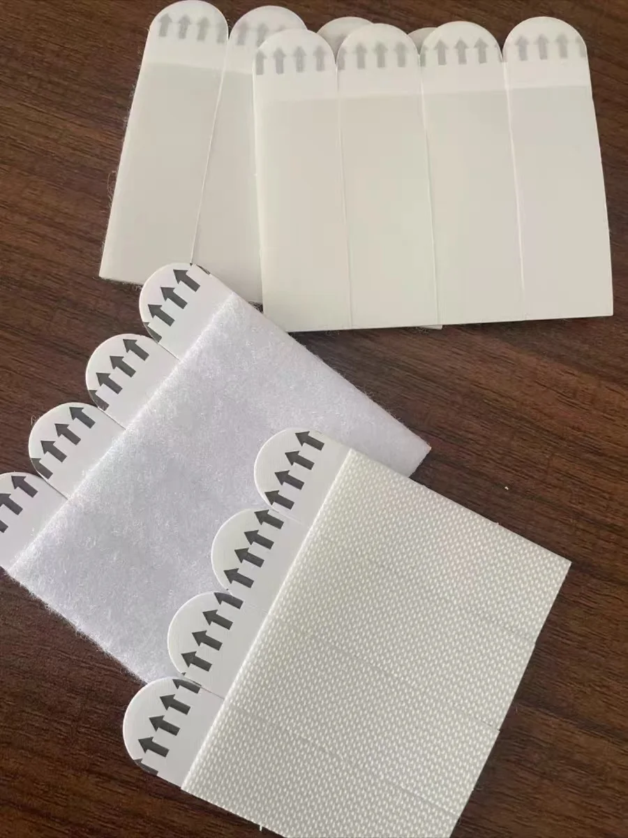 No-drill double-sided tape hooks with strong adhesive, suitable for picture frames and wall hanging. These magic tape strips are