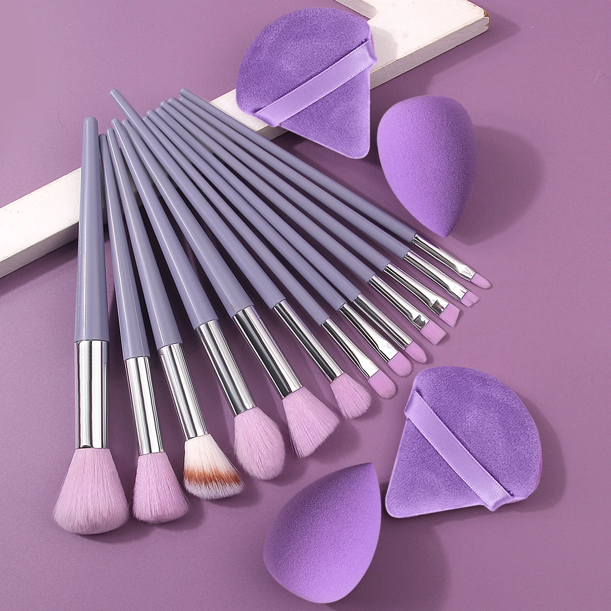 The 17-piece purple makeup brush set includes a multi-functional facial makeup brush/sponge egg/fan-shaped powder puff