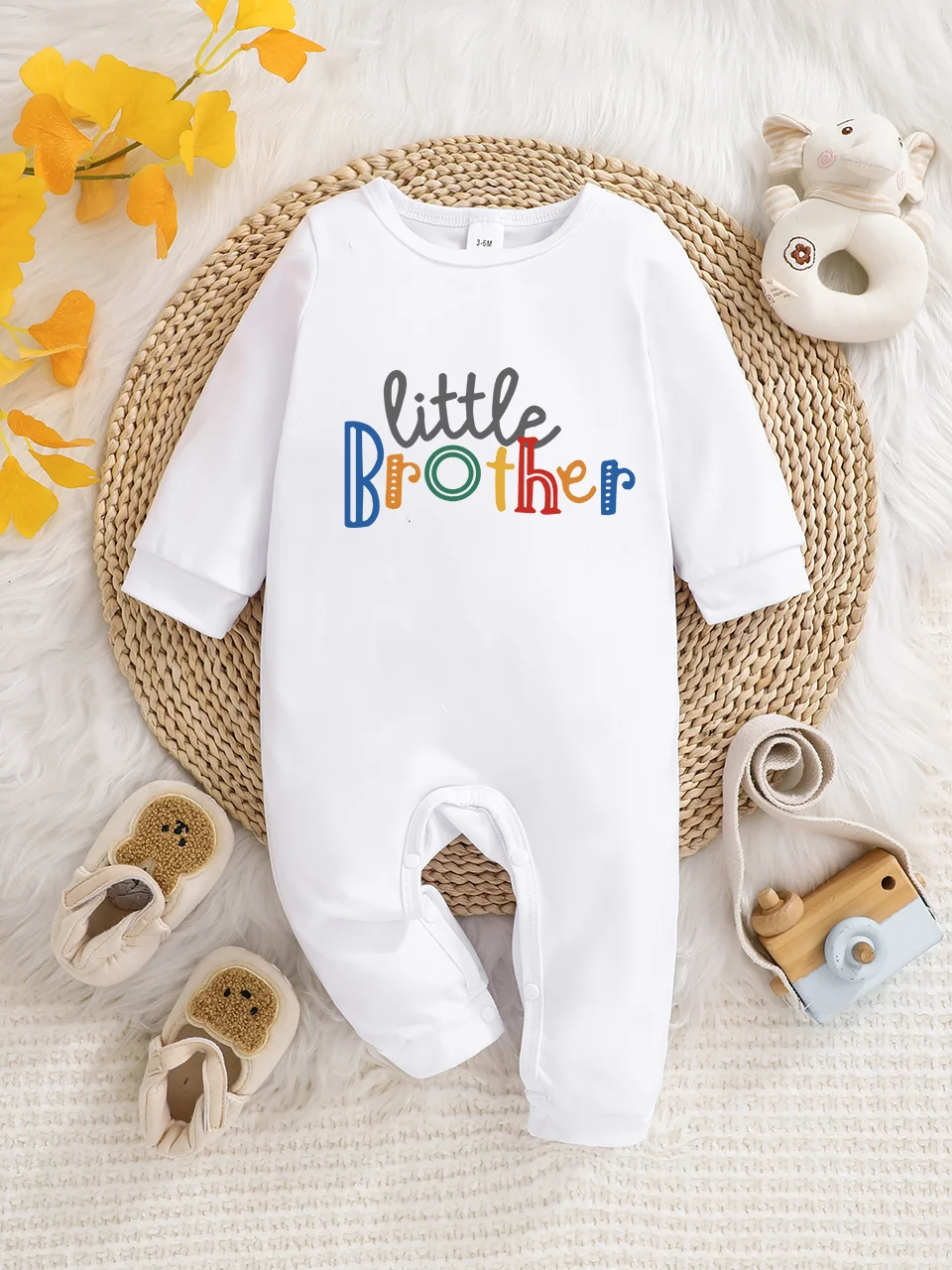 A baby long-sleeved onesie with interesting letter prints. It features a buttoned design for easy putting on and taking off