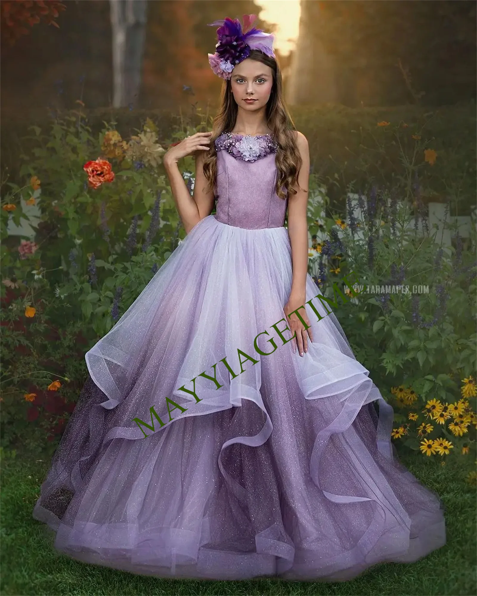 

Sprinkled with Glittery Fairy Dust Flower Girl Gown Features a Layered Ombre Skirt Cascading Overlay Floral Pearls