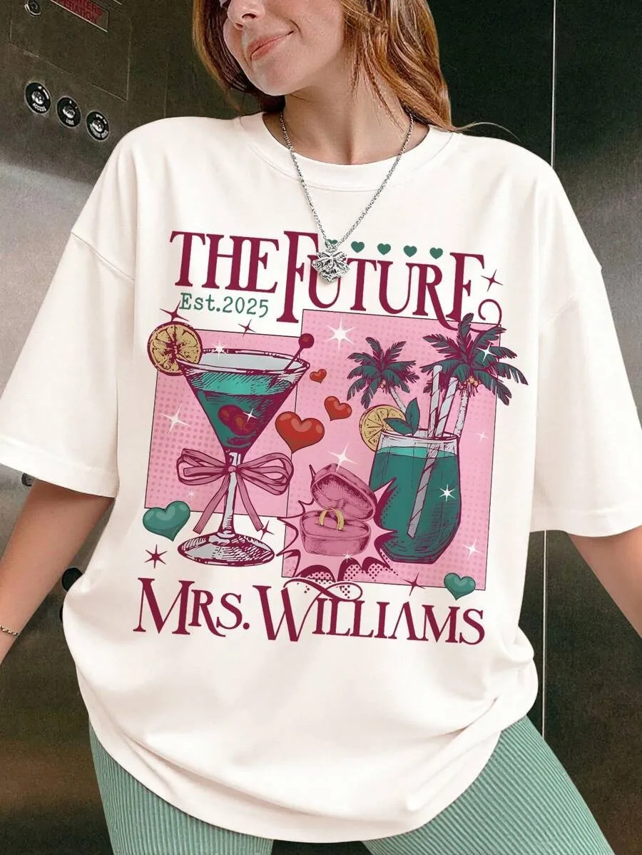 

Большой размер — белая футболка с короткими рукавами, надписью «THE FUTURE Est.2025 MRS. WILLIAMS» и коктейльной графикой