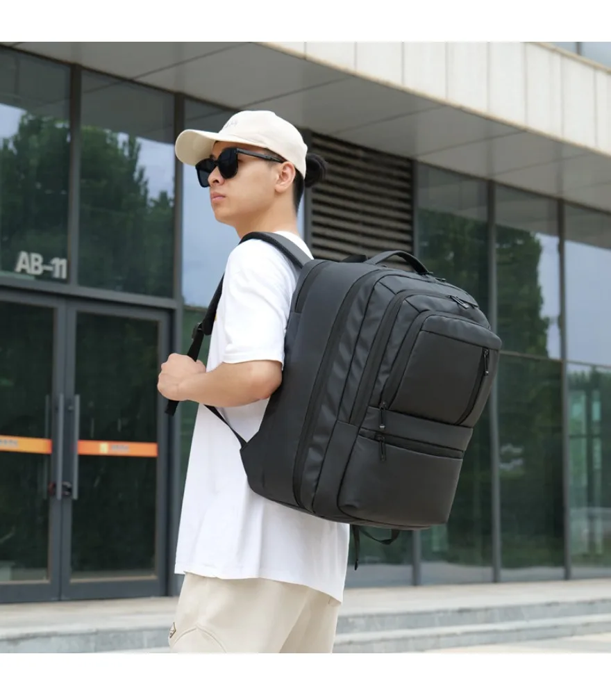 Black triple layered backpack with assorted metal zipper pulls anti splash padded back panel for daily office work storage