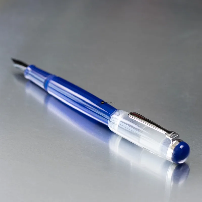OPUS 88 OMAR Transparent Sapphire Blue Resin Fountain Pen Large Drop-feed Ink Absorption, High Ink Capacity, PVD JOWO Black Nib