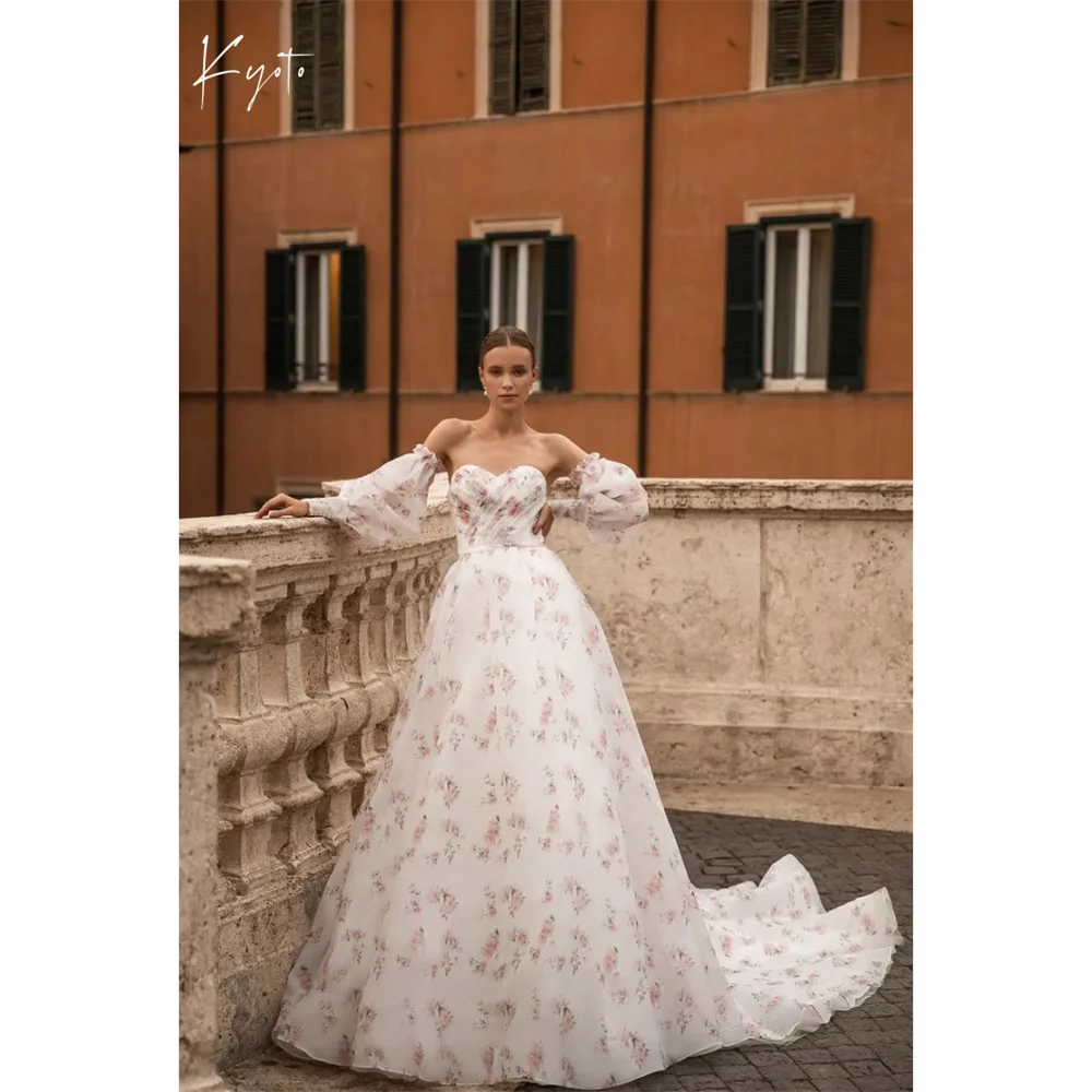 ชุดแต่งงานทรงเอไลน์แบบไร้สาย แขนกระดิ่ง แต่งลูกไม้ลายดอกไม้สไตล์โคจิโตะ คอร์เซ็ทยาวกรอมเท้า สำหรับงานพิธีการ ปี 2025