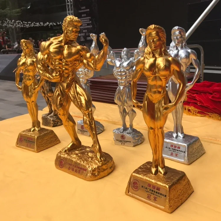 

Art Fitness muscle man sets up bodybuilding sports competition trophies, boxing figures, statues, sculptures, gym decorations