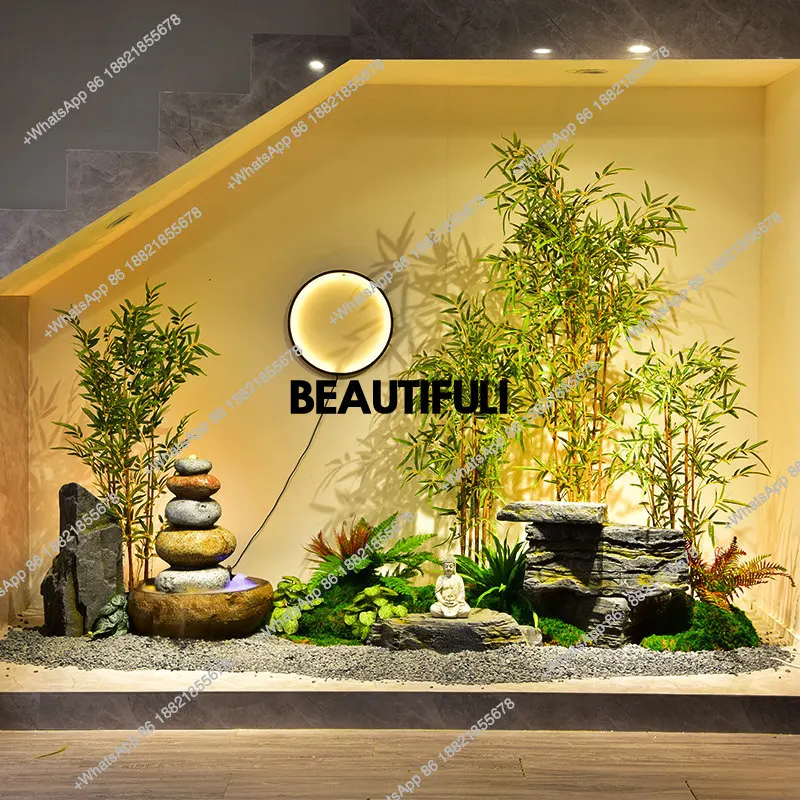 circulating water landscape, rockery stone landscaping under the stairs, simulated bamboo potted plants, image wall layout