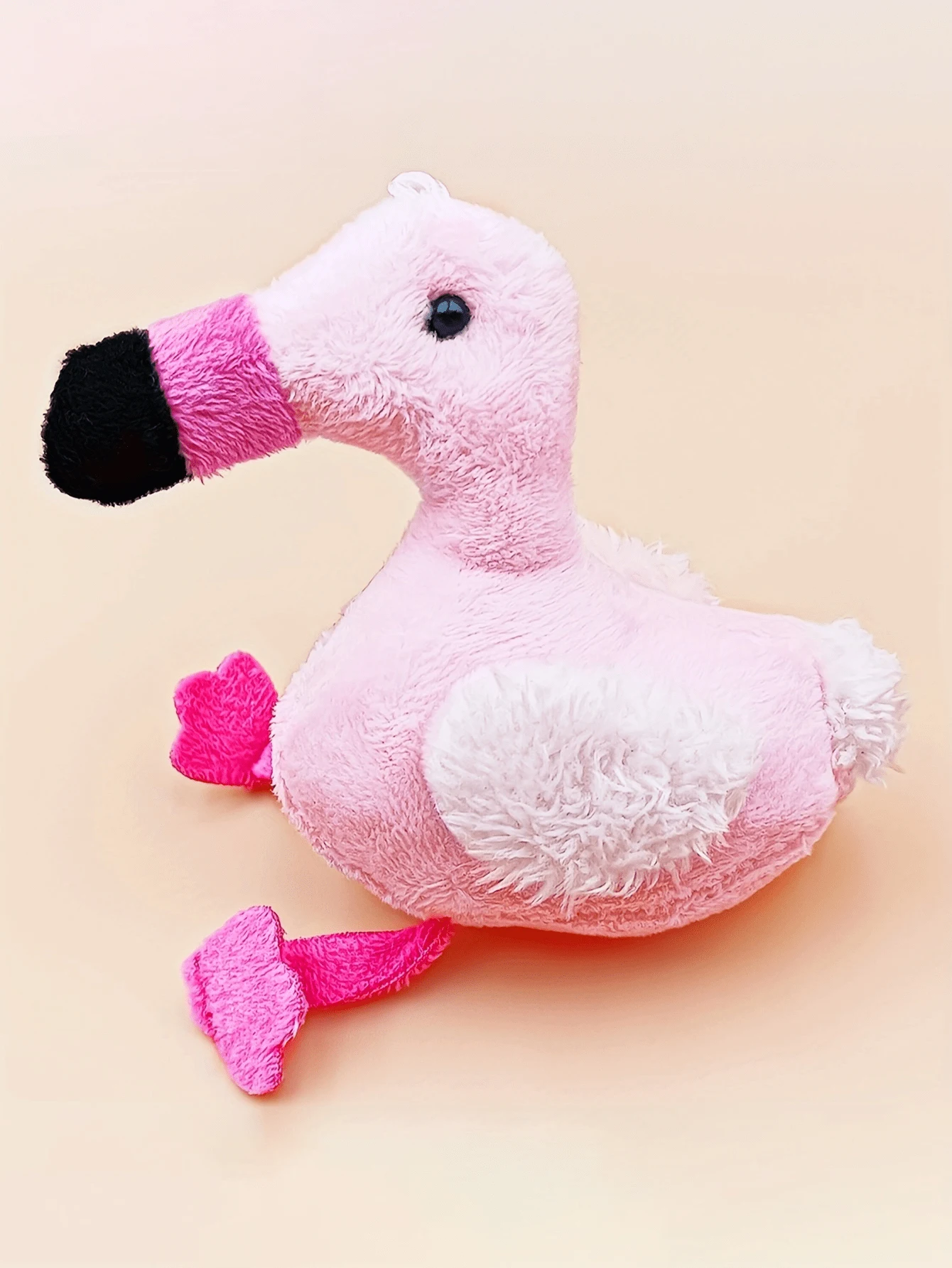 A mini flamingo plush toy suitable for pet companionship and play, not suitable for pets to chew and bite