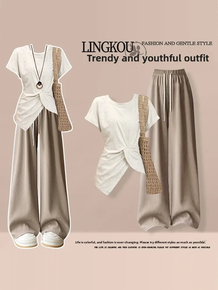 

Антивозрастной летний комплект для женщин: асимметричная футболка с эффектом похудения и повседневные брюки, комплект из двух предметов, большие размеры, модный дизайн с акцентом на плечах.