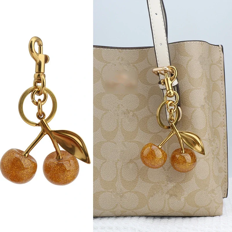 Dijes para bolsos para entrenador, bolsos de mano, colgante de cereza dorada brillante, llavero para mujer, accesorio festivo de Navidad