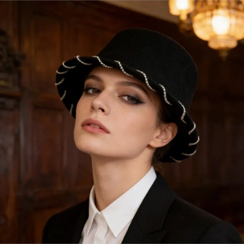An elegant black flat-topped top hat with a wavy and unique design in the style of Hepburn