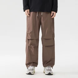 Pantalones de pierna ancha para hombre, pantalón de moda, estilo Safari, pliegues, bolsillos, cordón, suelto, informal, recto, primavera y verano, nuevo