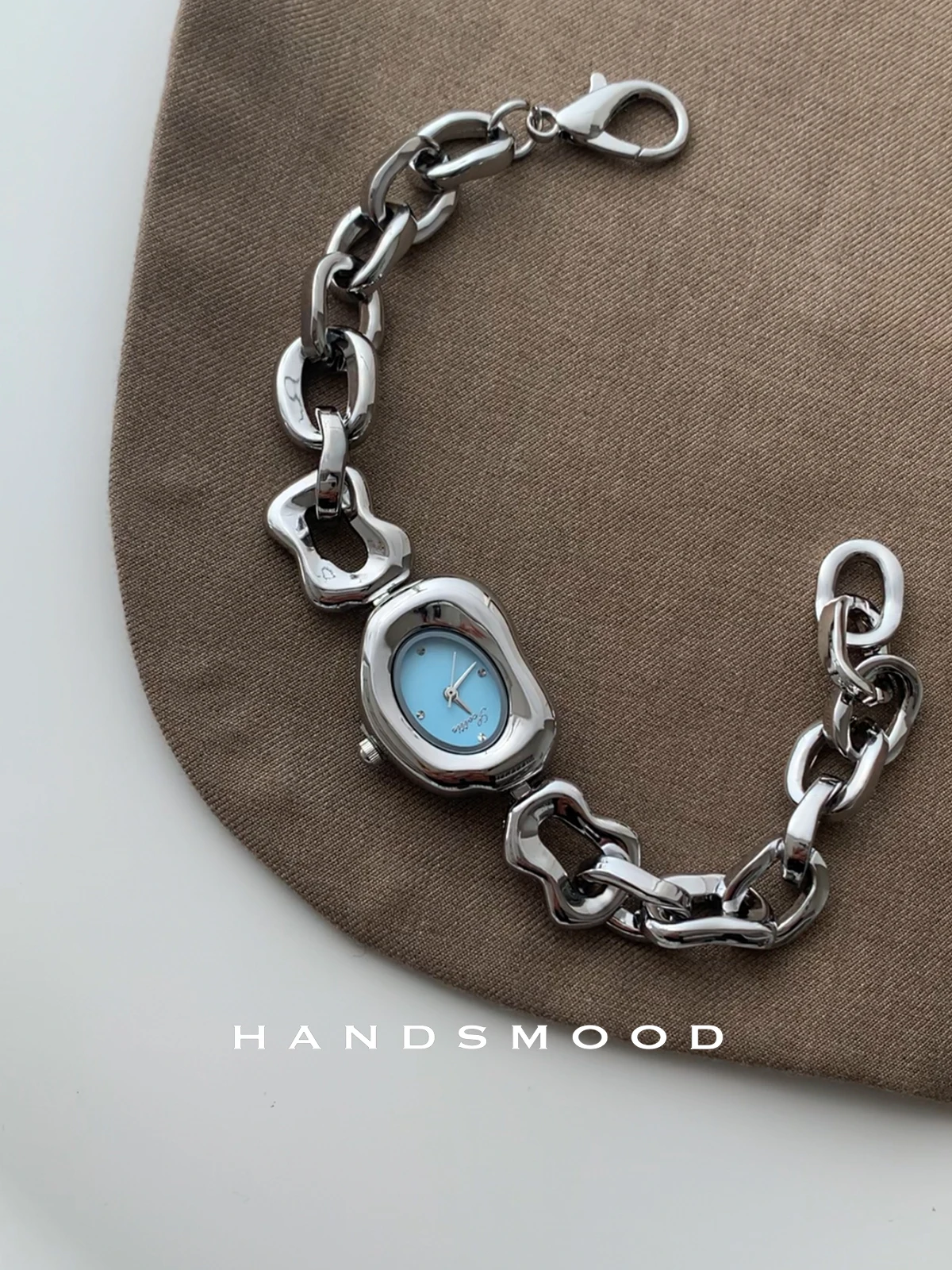 Elegant women's wristwatch, irregular silver-blue design, fashionable and sophisticated women's bracelet style watch.