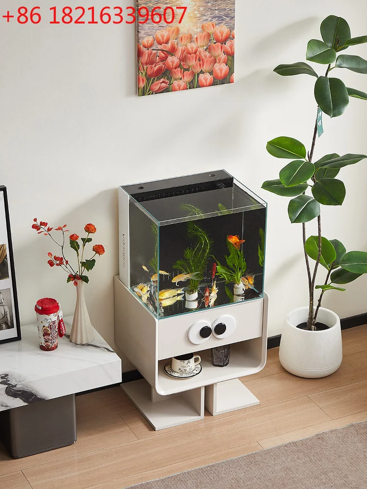 

Floor-to-ceiling small ultra-white glass back filter goldfish tank next to the TV cabinet in the living room