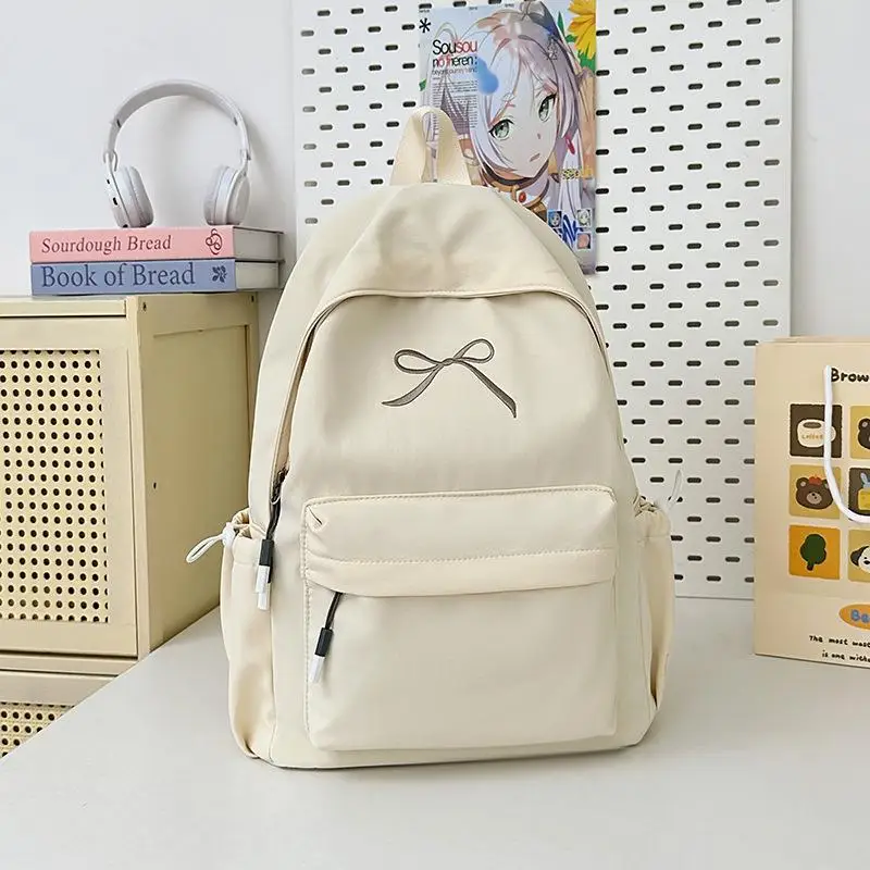 กระเป๋าเป้สะพายหลังสีพื้นน่ารักสไตล์เกาหลี ความจุเยอะ น้ำหนักเบา เหมาะสำหรับเดินทาง ปักลายโบว์  กระเป๋านักเรียน ของขวัญ