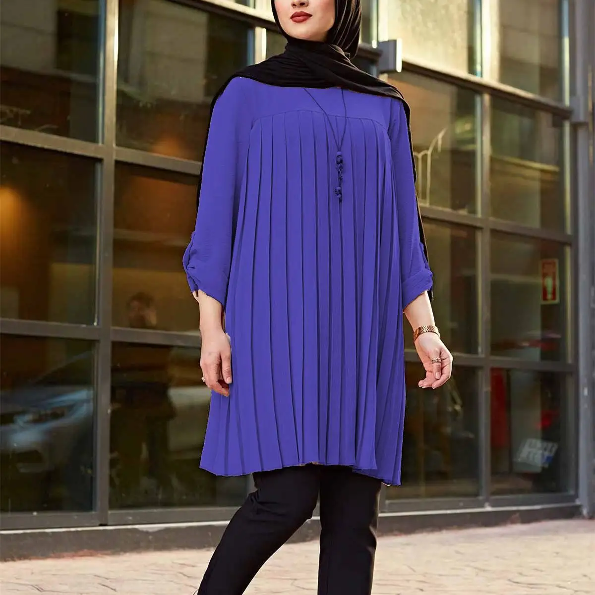 Royal blue pleated tunic with a relaxed silhouette and rolled sleeves