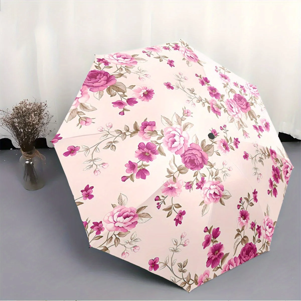 

Folding Umbrella The umbrella features a floral design with pink and purple roses, complemented by smaller blossoms and green