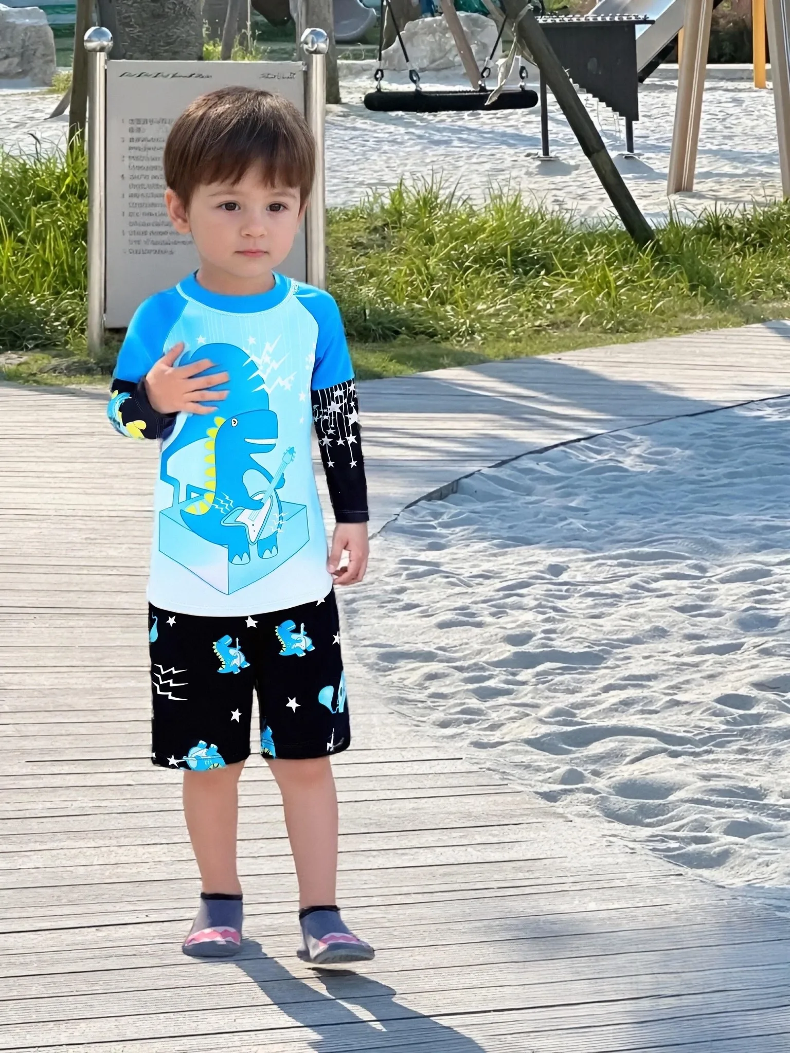 

Three-piece children's long-sleeved swimsuit with cartoon print and hood