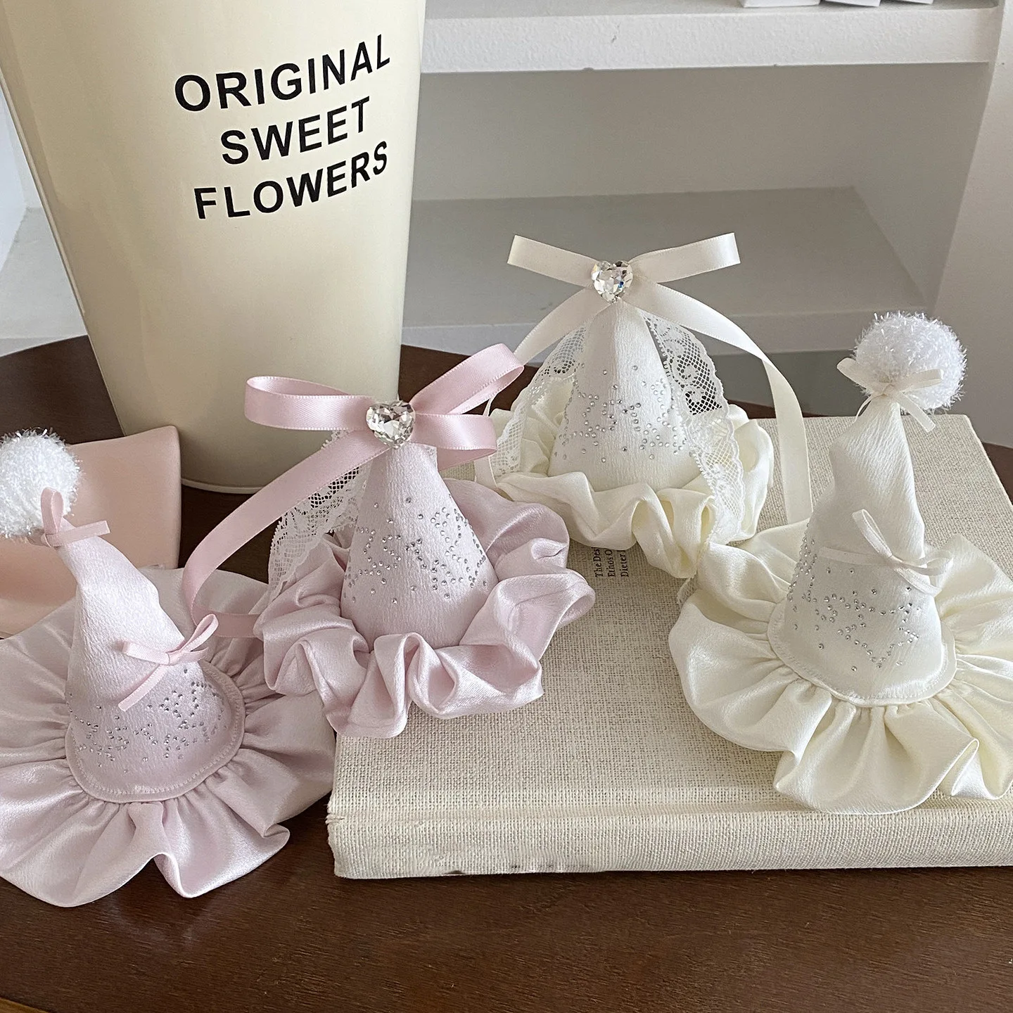 Cone-Shaped Hair Accessories with Ruffled Base — Faceted Gem Accent, Ribbon Bow, Two Color Variants on Textured Surface