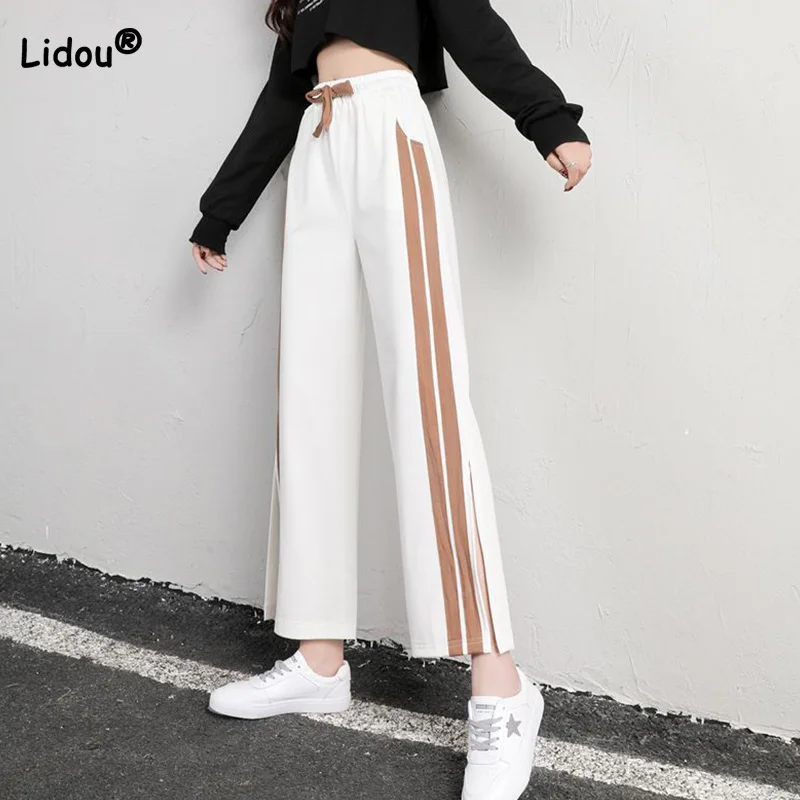 Casual coulisse vita alta gamba larga signora Streetwear tasche banda laterale bianco tutto-fiammifero primavera estate Split sport nono pantaloni