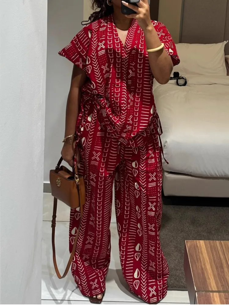 

Новый модный комплект из двух предметов: женская свободная повседневная рубашка с коротким рукавом, V-образным вырезом и завязками на талии, а также широкие брюки.