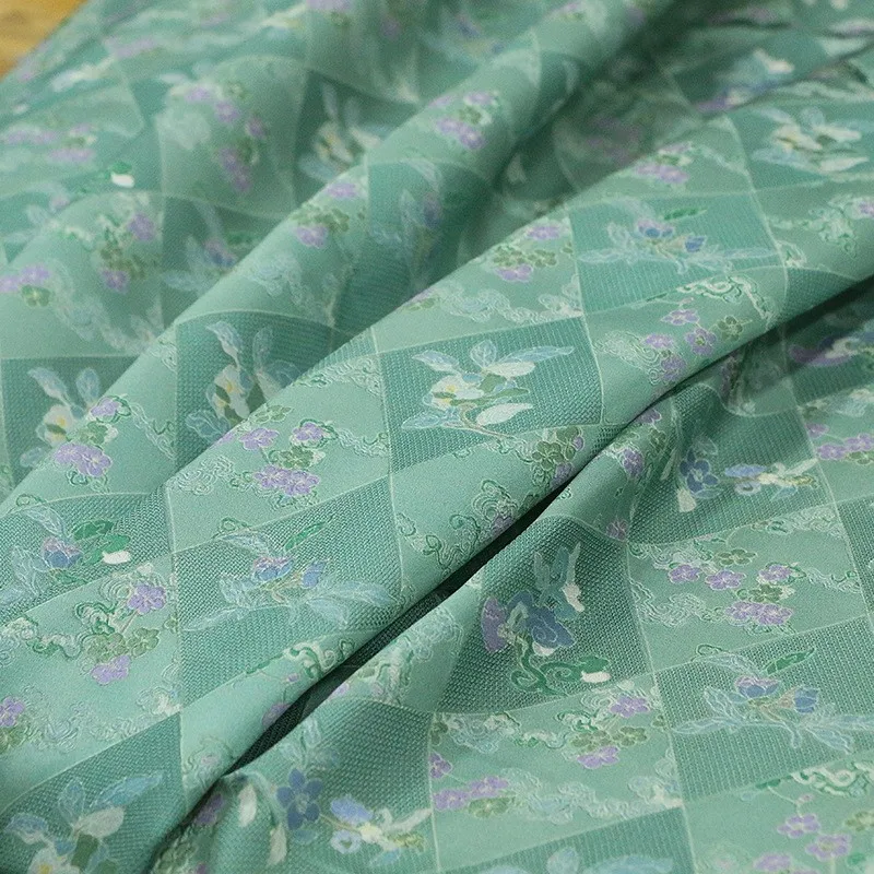 

Spring new style silk jacquard perforated flower fabric printed green base plum blossom traditional Chinese cheongsam