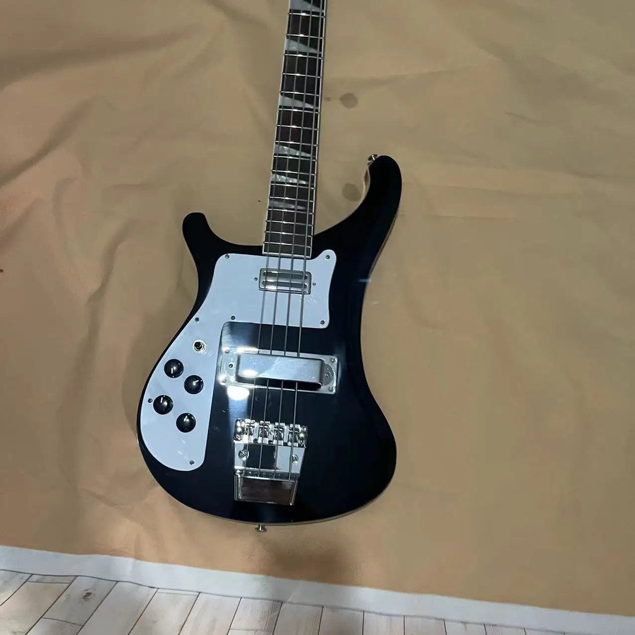 In stock, there is a left hand four chord Rickenbaker electric bass with a black body and chrome plated accessories. The factory