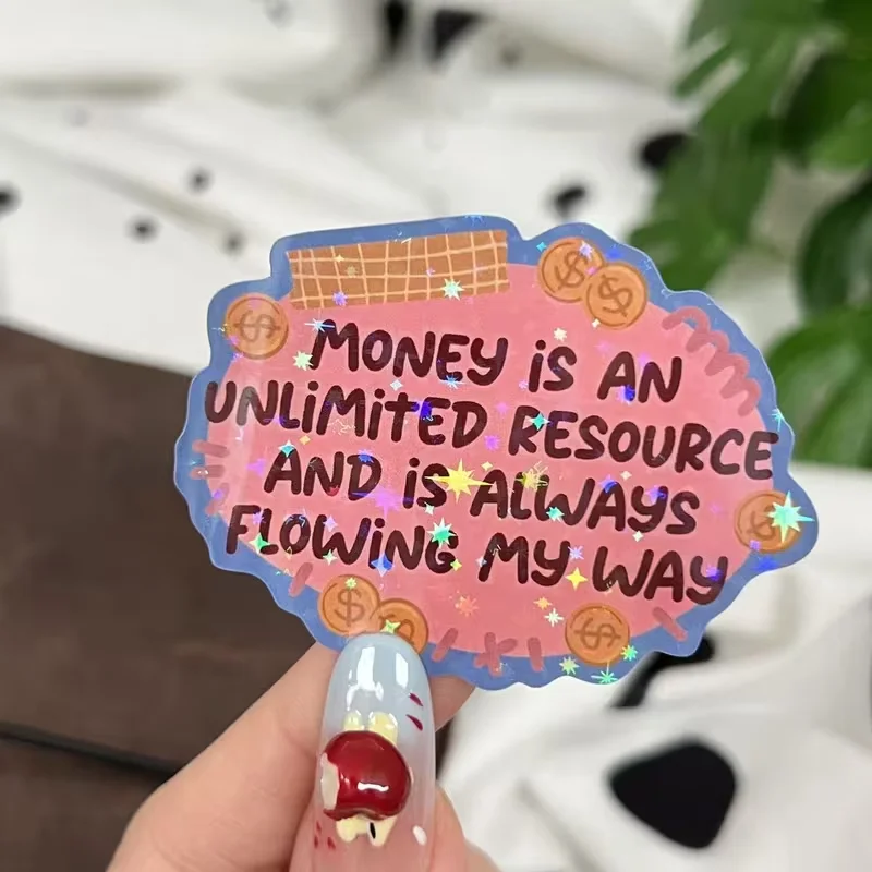 Les autocollants de manifestation et d'affirmation sont ornés du slogan « L'argent est une ressource illimitée » et du symbole du dollar.