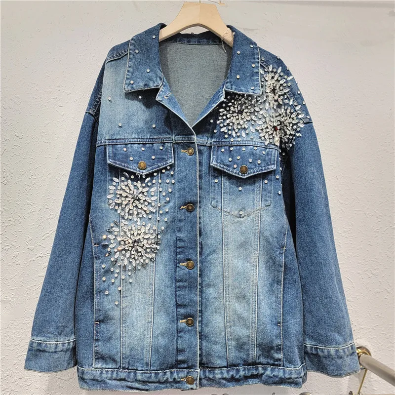 

European-inspired denim jacket. Features intricate hand-beaded shoulders & a relaxed, flattering fit for standout style.