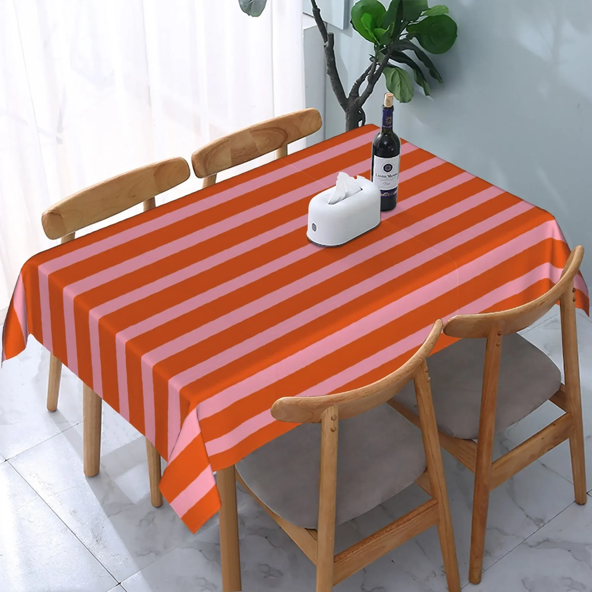 One lively orange and pink striped tablecloth, enhancing the fresh aesthetics of the homezyc