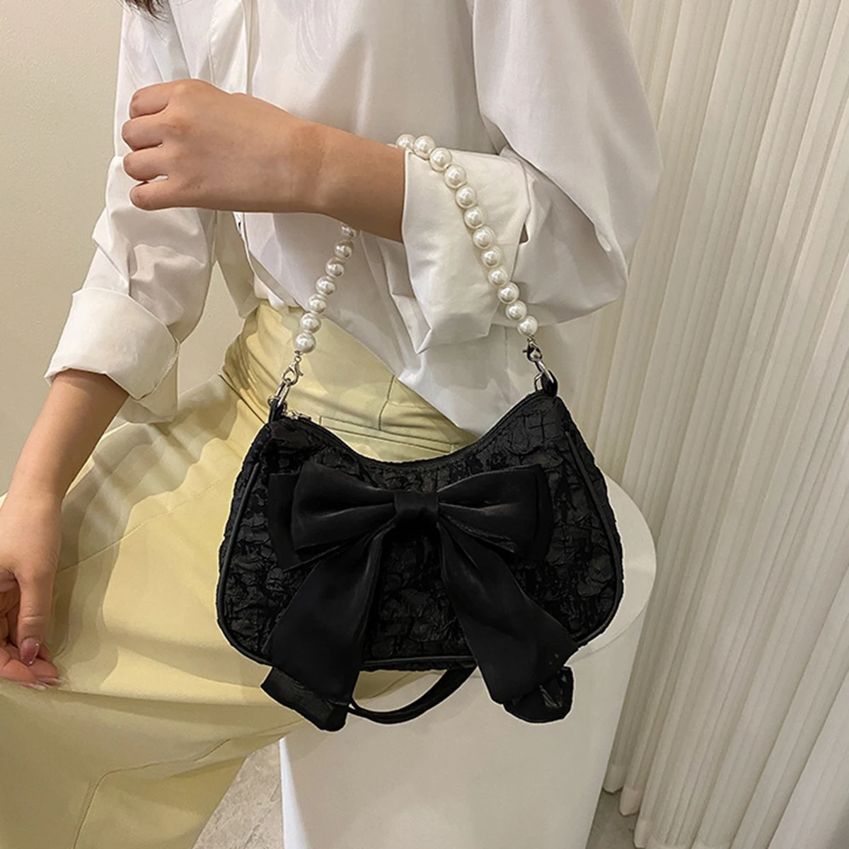 White folds pop retro bow bag Female Pearl handle New fashion pearl armpit shoulder crossbody bag 1 outfit view 2